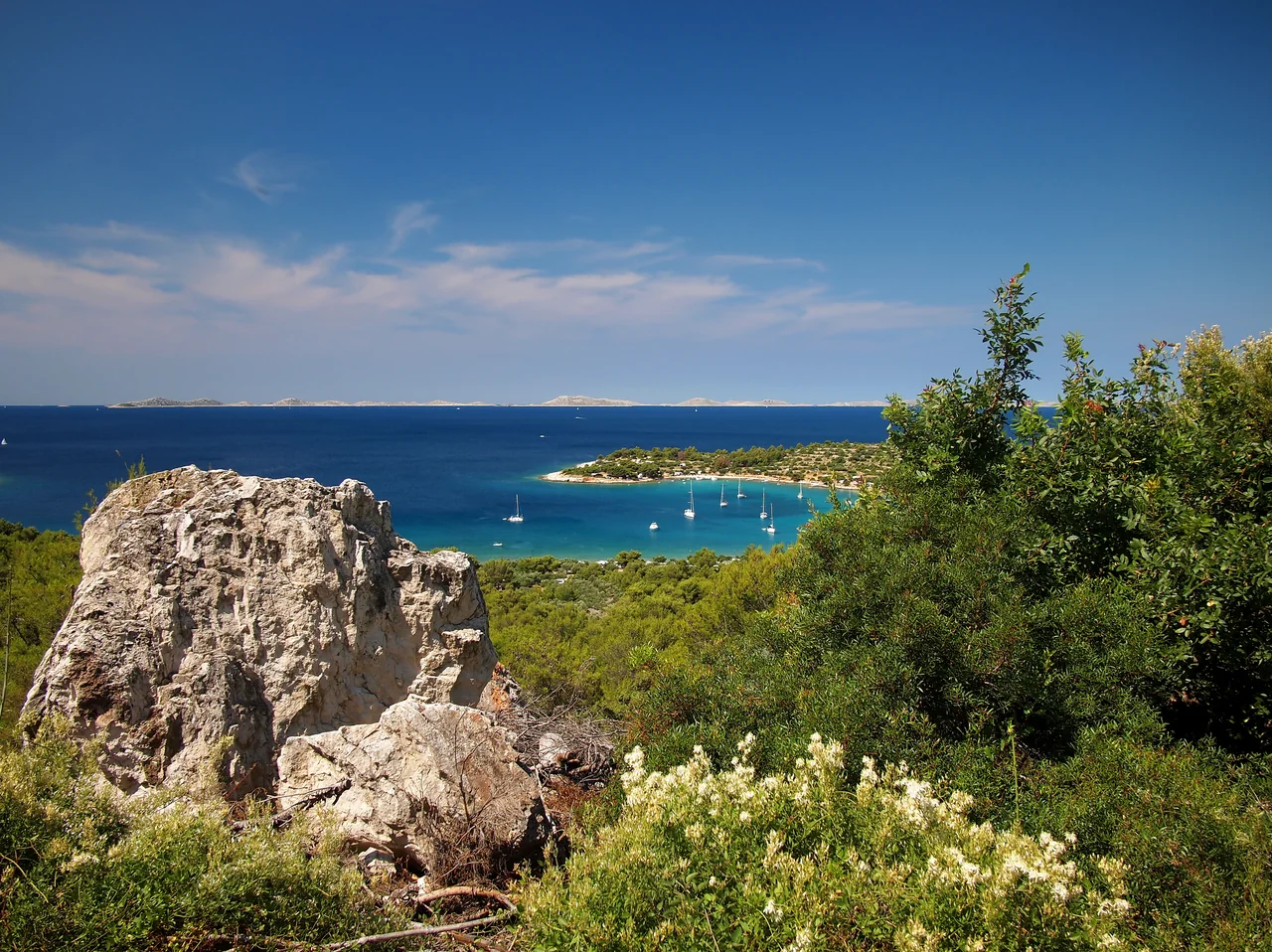 Sailboats in the turquoise bay of Kosirina on Murter Island